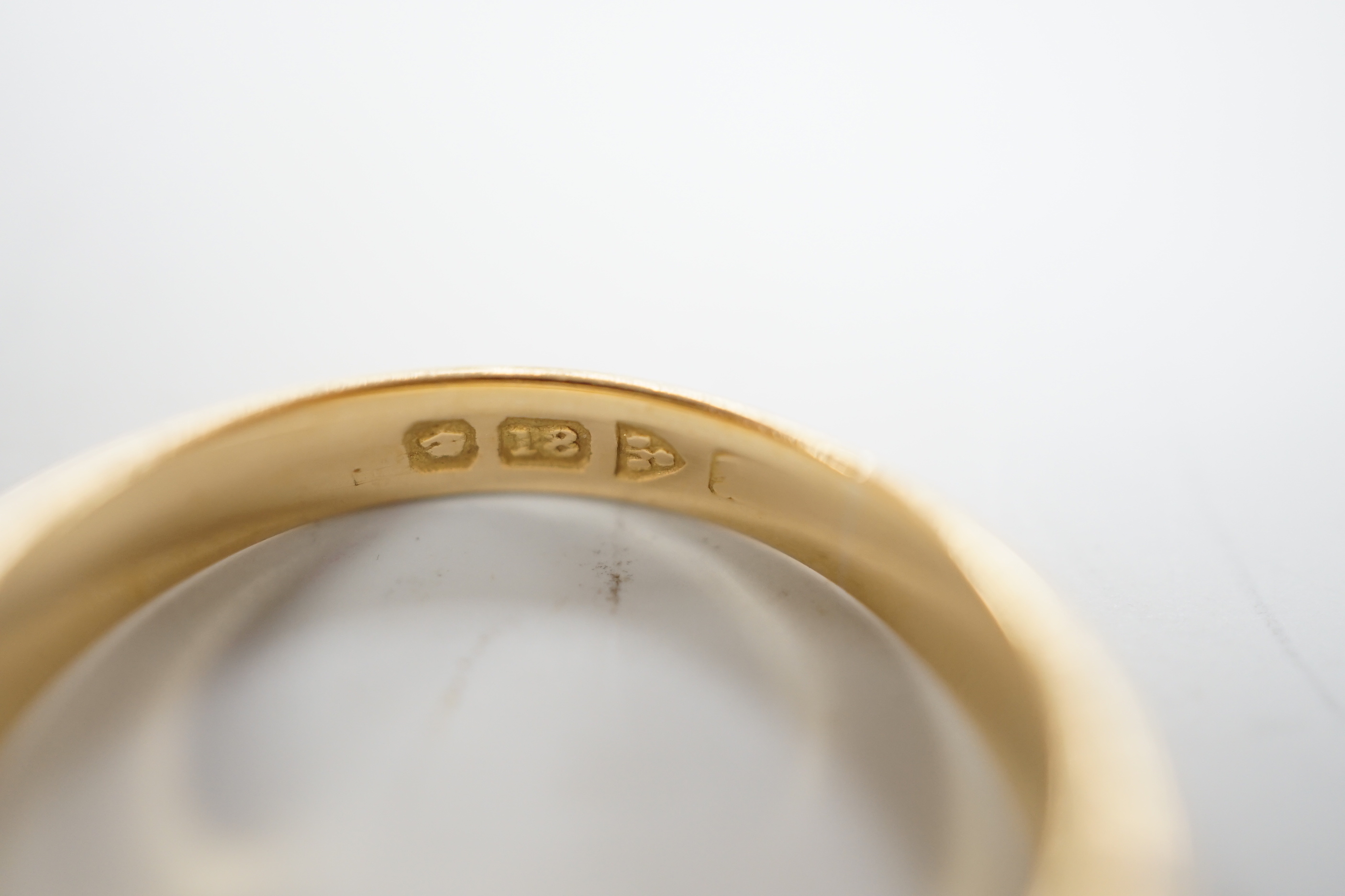 An early 20th century 18ct gold and gypsy set single stone diamond and two stone sapphire set ring, size O, gross weight 6.4 grams.